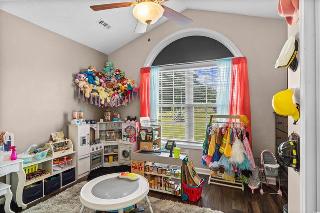 Game room featuring a ceiling fan, wood finished floors, and lofted ceiling | Image 15