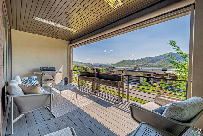 Wooden deck with a mountain view and grilling area | Image 26