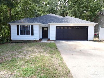 Single story home with a garage and a front yard | Image 1