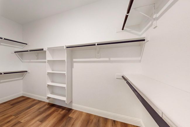 Spacious closet featuring dark hardwood / wood-style flooring | Image 13