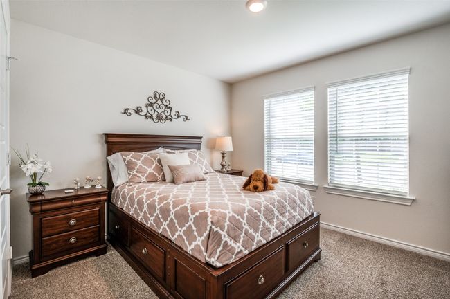 Bedroom featuring light carpet and baseboards | Image 18