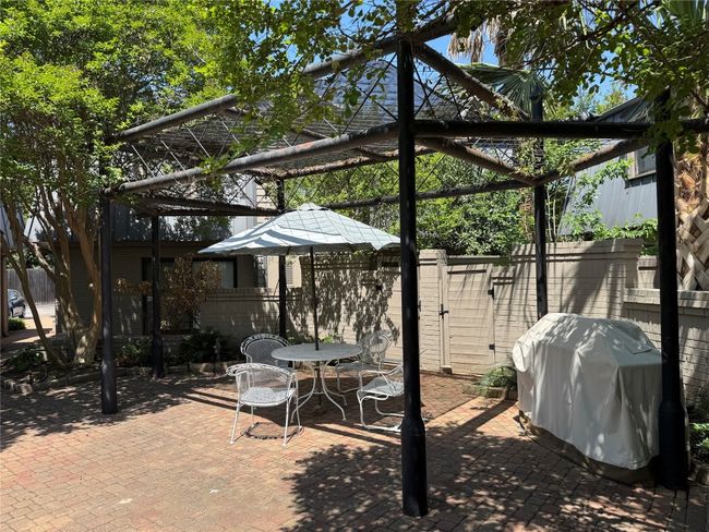 View of courtyard with a grill and seating area | Image 23