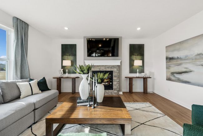 (Photo of model home, actual features may vary) This modern fireplace with natural stone surround is an extraordinary room accent. Enjoy the warmth of this gas fireplace during the cool fall and winter as you relax in your family room. | Image 6