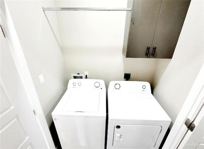 Laundry area with cabinets and washer and dryer | Image 6