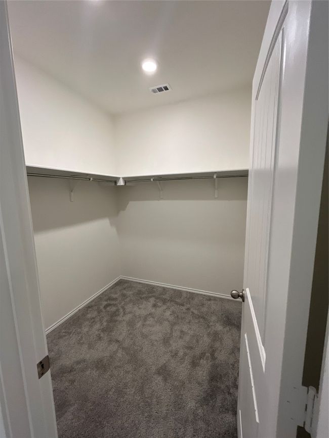 Walk in closet with carpet floors and visible vents | Image 17