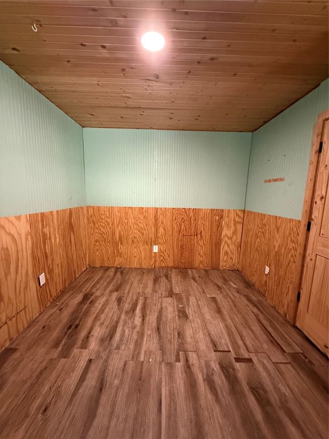 Empty room featuring wood ceiling, wood finished floors, wooden walls, and a relaxing sauna | Image 28