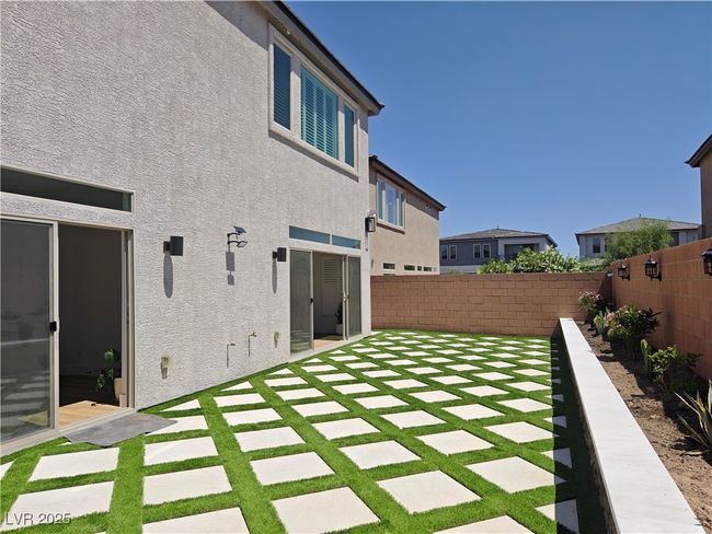 Rear view of property with stucco siding, a patio, and a fenced backyard | Image 45