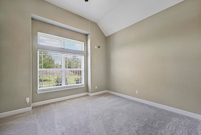 Carpeted bed room featuring healthy amount of natural light, lofted ceiling, and ceiling fan | Image 20