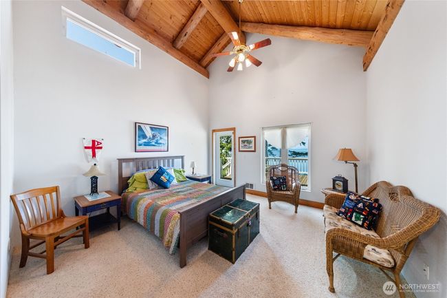 Upper-level bedroom with deck access. | Image 19