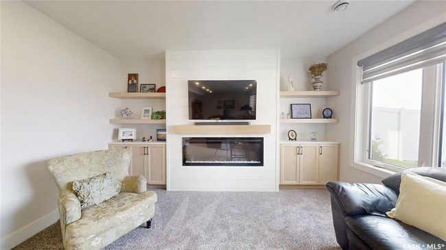 Living area featuring a large fireplace, healthy amount of natural light, and carpet flooring | Image 25