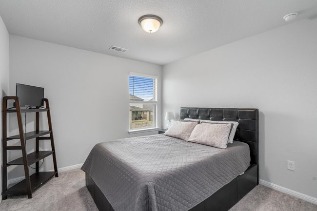 Carpeted bedroom with baseboards | Image 23