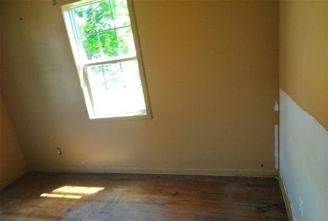 Spare room with healthy amount of natural light and wood finished floors | Image 4