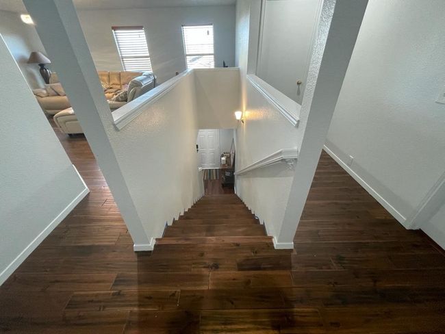 Staircase with wood finished floors and baseboards | Image 11