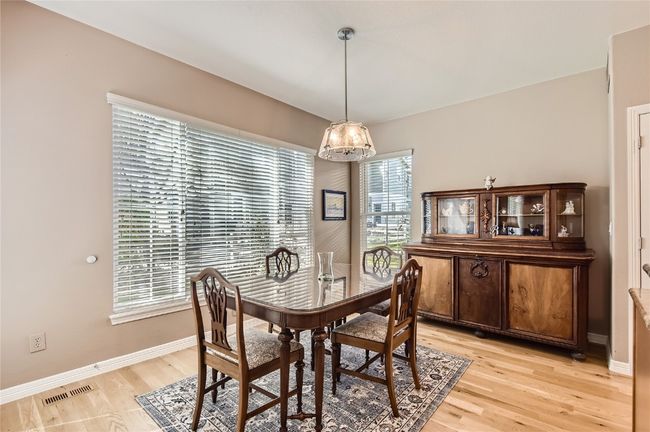 Dining room with sunny views of the back yard | Image 7