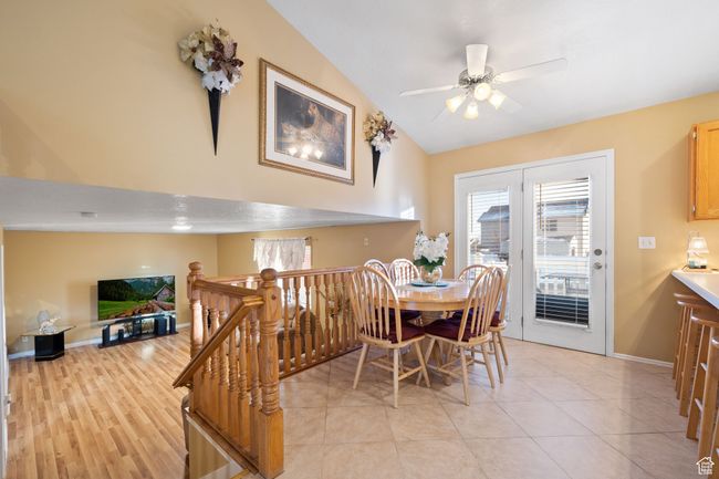 Tiled dining room with vaulted ceiling and ceiling fan | Image 14