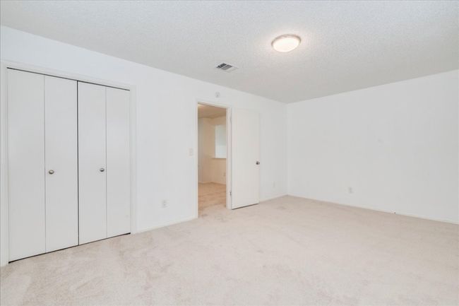 Unfurnished bedroom featuring carpet floors, a closet, and a textured ceiling | Image 29
