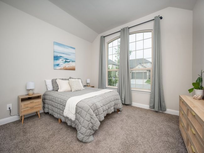 This cozy secondary bedroom features plush carpeting, soft, soothing paint tones, and ample natural light! | Image 12