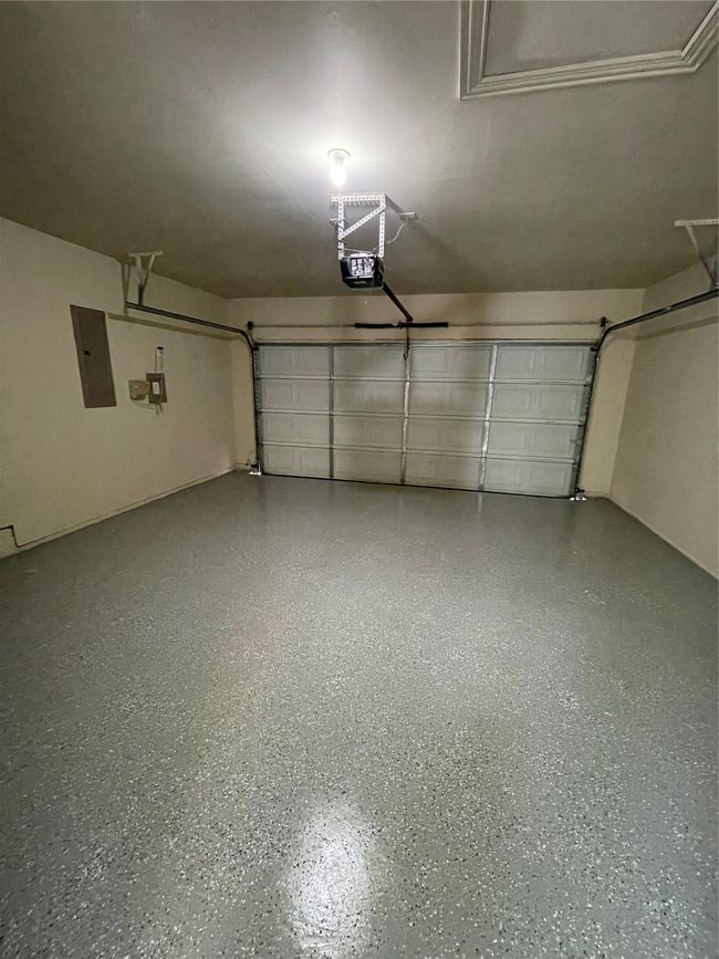 Garage featuring a garage door opener and electric panel | Image 19