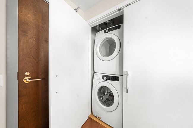 Laundry area featuring stacked washer and clothes dryer | Image 33
