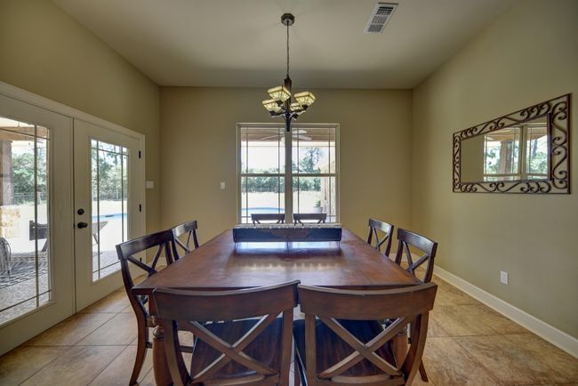 Light and bright dinning room overlooking pool and backyard. | Image 13