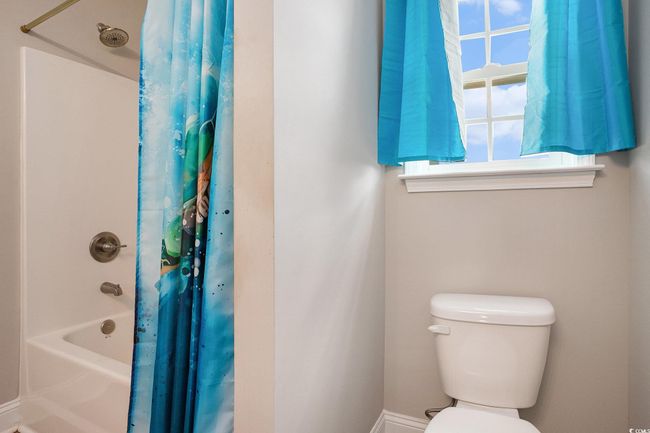 Full bathroom featuring toilet and shower / bath combo | Image 20