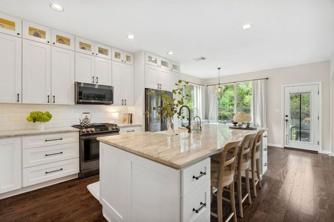 The kitchen is the heart of the home with an oversized island that invited guest to gather around. | Image 8