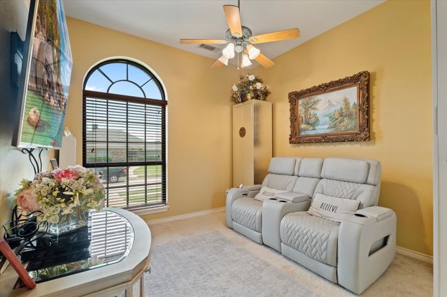 Living area featuring carpet, a ceiling fan, and baseboards | Image 25