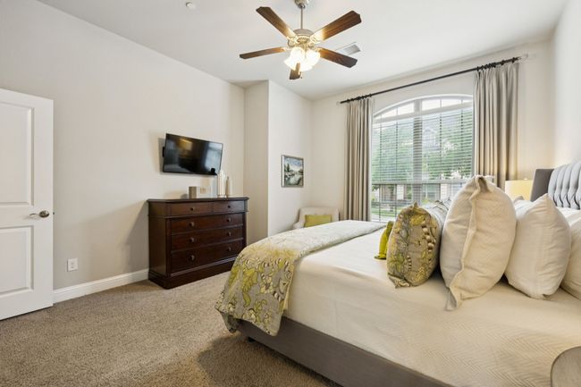 Bedroom with carpet floors and a ceiling fan | Image 12