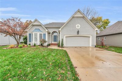 View of front of property with a garage and a front lawn | Image 1