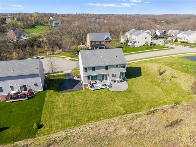The home offers great outdoor space including a deck, stamped concrete patio, large flat yard and wide driveway. | Image 27
