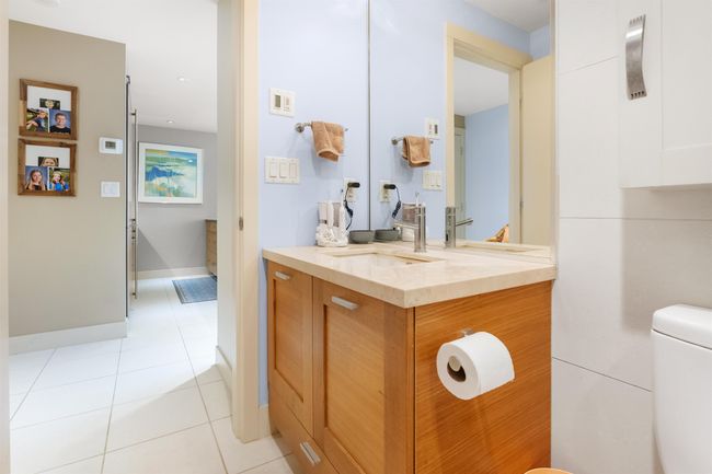 Bathroom with vanity, toilet, tile patterned flooring, and baseboards | Image 10