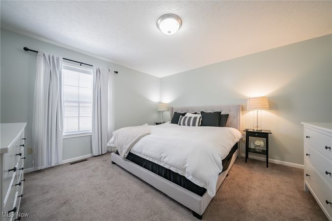 Bedroom with light colored carpet | Image 15