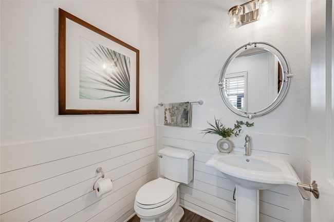 half Bathroom with toilet and wood finished floors | Image 25