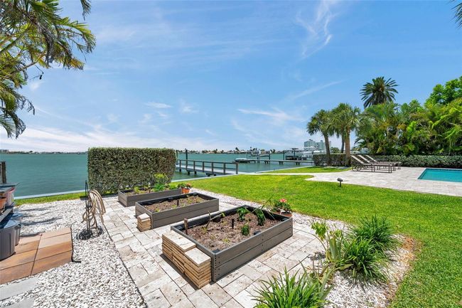 Three Trex garden boxes surrounded by travertine pavers. The hedgerow near the seawall provides some protection from wind sheer and early morning sun. | Image 94