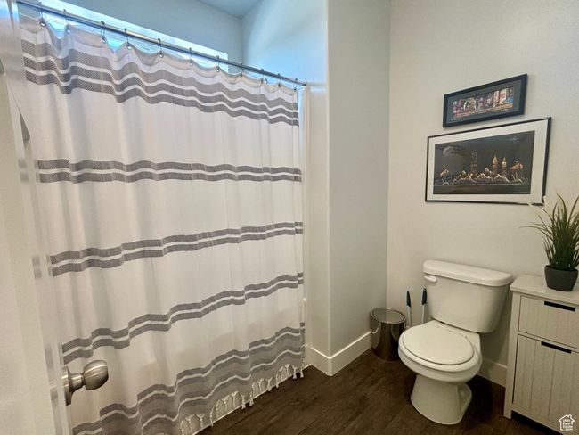 Bathroom with walk in shower, wood-type flooring, vanity, and toilet | Image 10