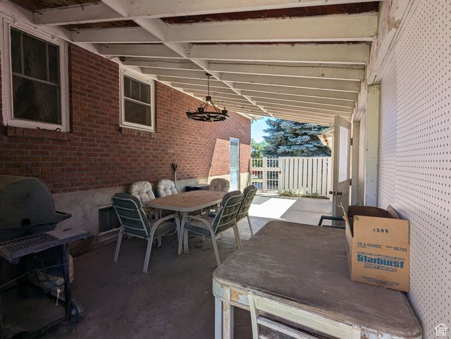 View of patio featuring grilling area and outdoor dining area | Image 22