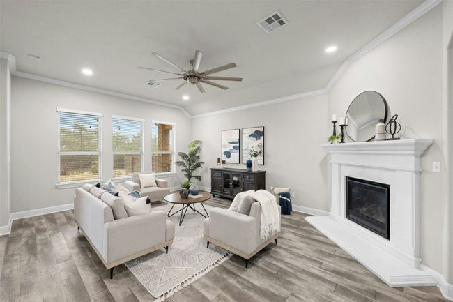 A cozy gas log fireplace serves as the focal point of the living room, adding both warmth and elegance. | Image 7