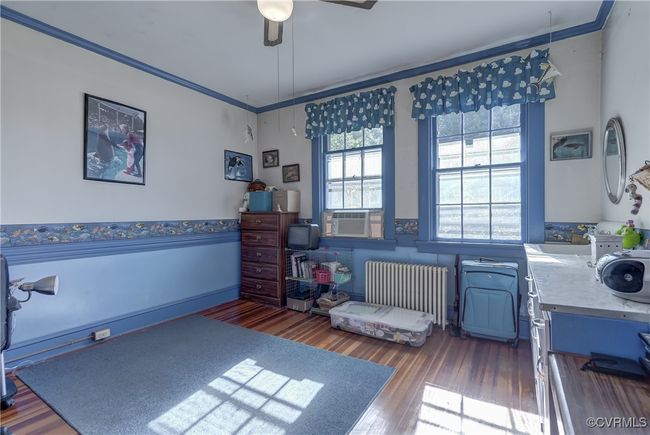 Office featuring crown molding, ceiling fan, wood finished floors, radiator, and cooling unit | Image 21