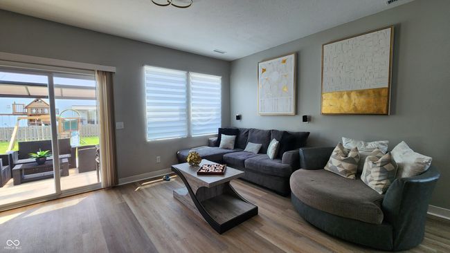 living area featuring wood finished floors and healthy amount of natural light | Image 8