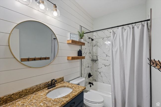 Full bath with vanity, shower / bathtub combination with curtain, and toilet | Image 11