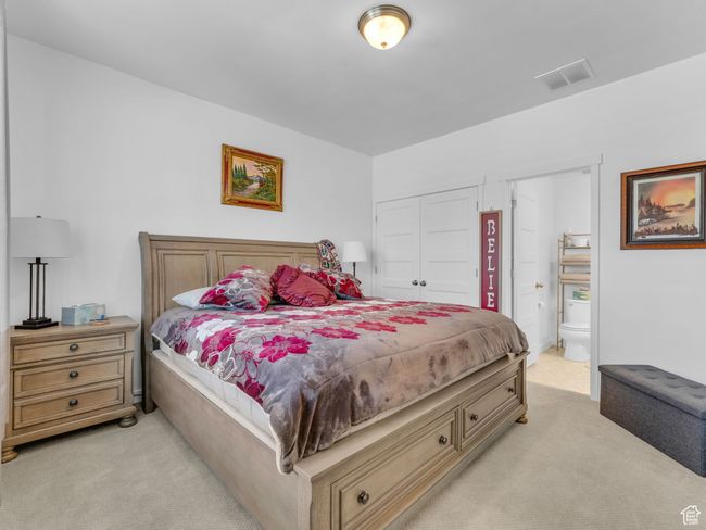 Bedroom 1 featuring light colored carpet, a closet, and ensuite bathroom | Image 19