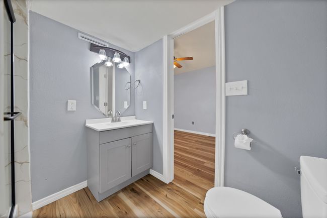 Bathroom featuring vanity, wood finished floors, and a ceiling fan | Image 11