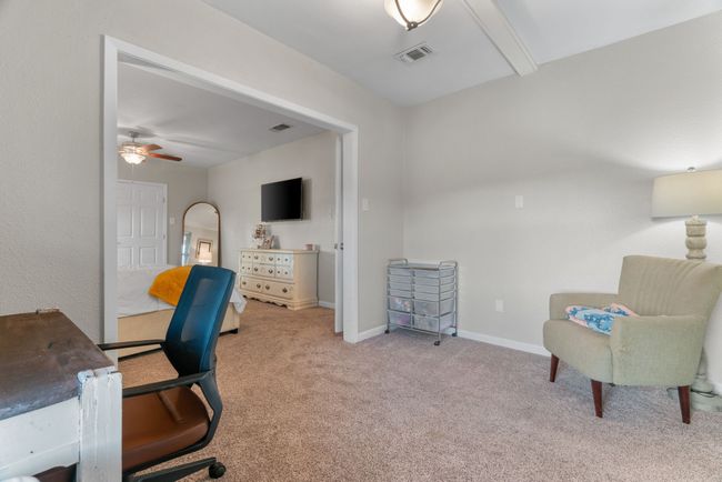 Carpeted home office featuring a ceiling fan and baseboards | Image 29