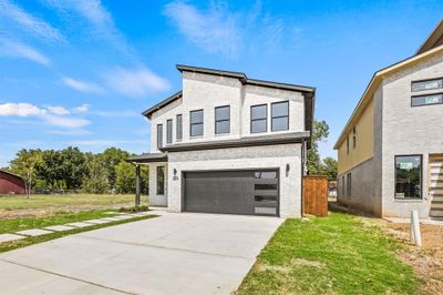 View of front facade with a garage and a front lawn | Image 3