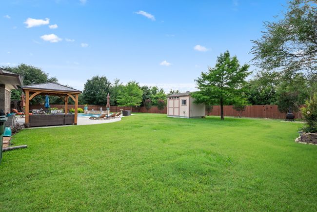 Fenced backyard with a gazebo, a storage shed, outdoor lounge area, and a patio area | Image 35