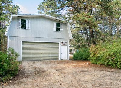 Spacious 2 car garage with storage above and outbuilding beyond | Image 3