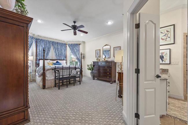 Carpeted bedroom with ceiling fan and ornamental molding | Image 27