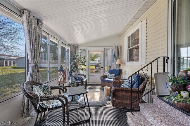 Sunroom / solarium featuring vaulted ceiling | Image 19
