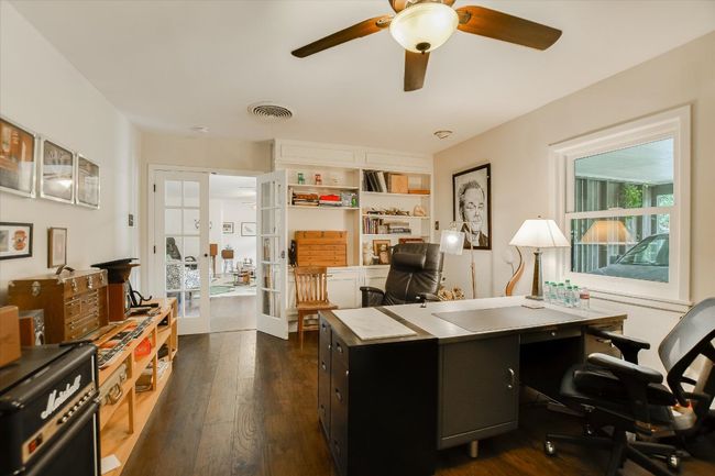 Office area featuring french doors, a ceiling fan, and dark wood-style floors | Image 11