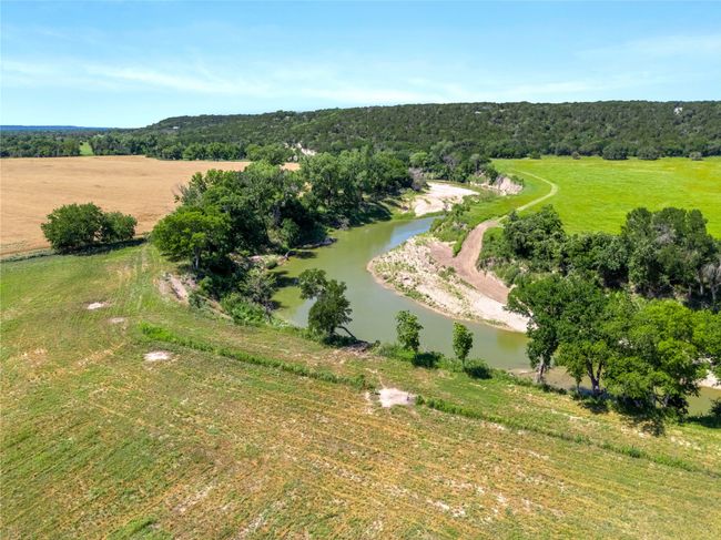 Overview of rural landscape featuring a large body of water and a forest | Image 27